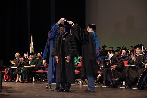 Alfred Amuzo receives the JD academic hood