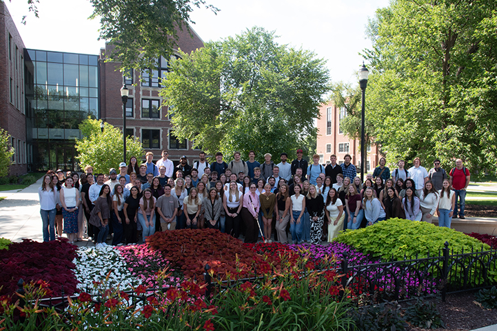 Members of the UND School of Law Class of 2029 gather for a photo in front of the School of Law during orientation week.