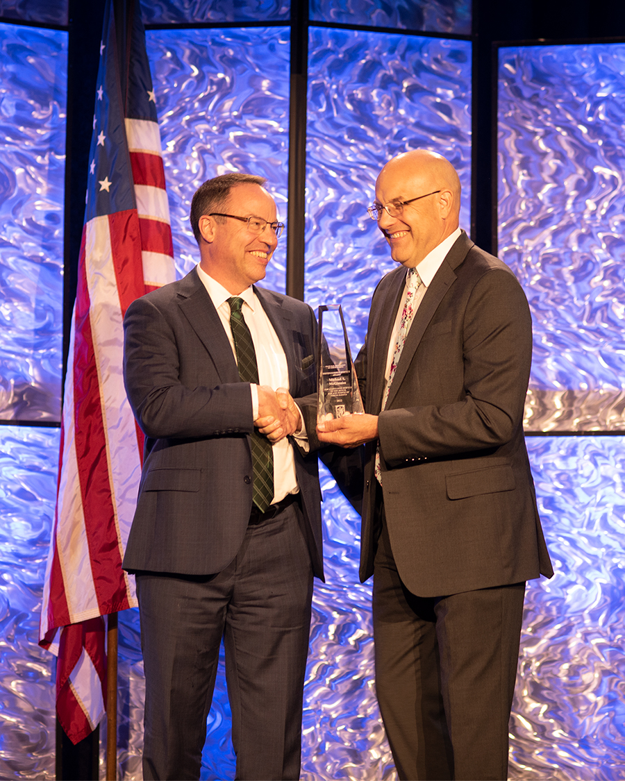 Doug Bahr presents Dean McGinniss with Distinguished Service Award