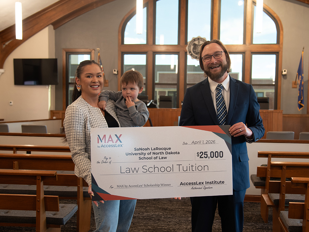 AccessLex representative, Zachary Smith, presented the scholarship to SaNoah Larocqu (pictured with her son).